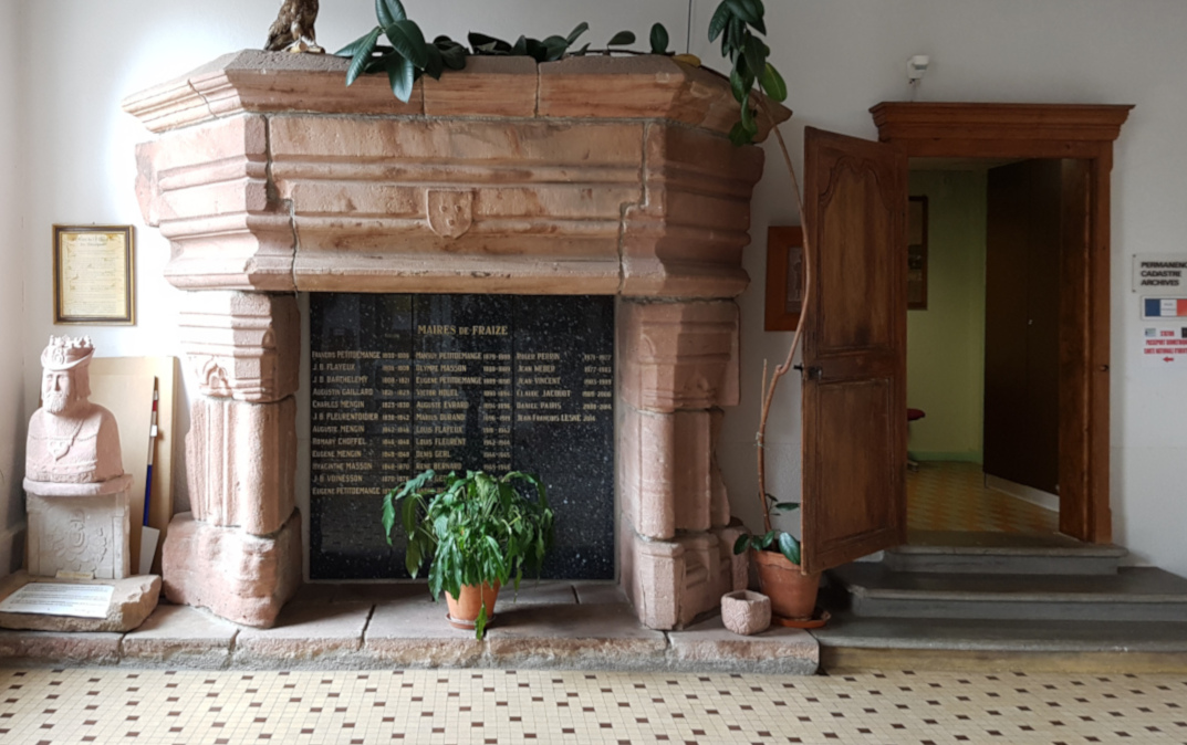 La cheminée de grès rose et la porte restaurées dans le hall de la mairie.<br>
	Notez le blason des Ribeaupierre au centre de la hotte.